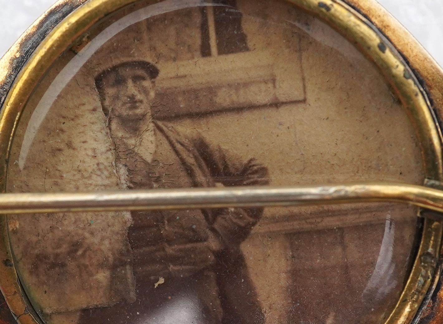 A Victorian gold demi-parure, late 19th century, comprising: a brooch and a pair of earrings, each centring on a circular-cut emerald withing a star border, within mounts accented with stepped and beaded decoration, the